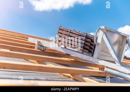 roof tiles on a lift for the transport to the roof during laying Stock Photo