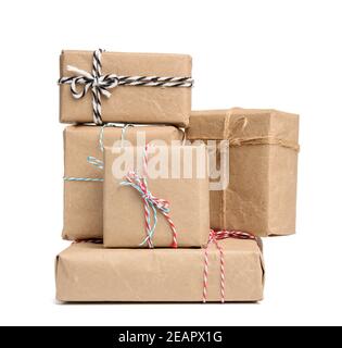 big stack of gifts wrapped in brown kraft paper and tied with rope Stock Photo
