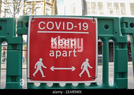 'COVID-19 Keep Apart' sign on Oxford Street, London.Most businesses remain shut in the UK as the nation continues to battle with the coronavirus pandemic. Stock Photo