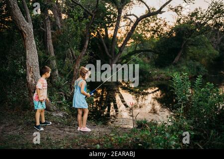 Boy walking fishing pole summer hi-res stock photography and