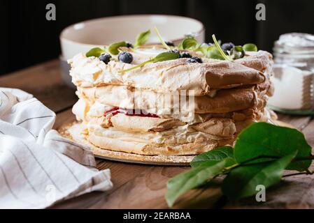 easter, easter cake on a dark background with a complex composition, beautiful scenery, dried fruits, movement, hands Stock Photo