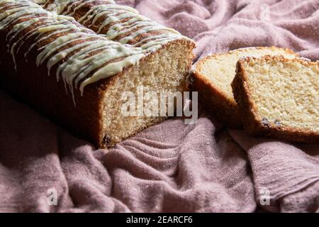 Close-up of homemade sponge cake cut with chocolate chip and white chocolate on top Stock Photo