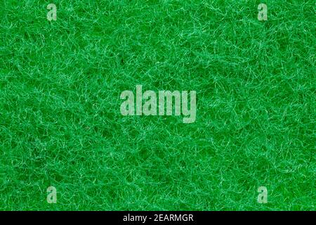 Green sponge texture. Closeup of the rough side of a kitchen sponge for cleaning of of pots and pans. Cellulose or foam sponge background. Macro. Stock Photo