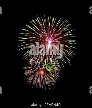 Beautiful colorful fireworks exploding in the night sky, isolated on black background Stock Photo