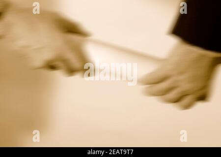 Two Businessmen hands passing the baton in a relay race. Stock Photo