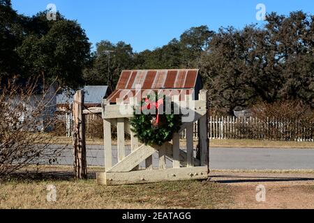 A Christmas wreath hangs on the front entrance gate of the historic Boyhood Home of former President Lyndon Baines Johnson in Johnson City, Texas. Stock Photo