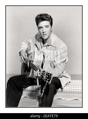 Elvis Presley 1950’s B&W publicity studio still. King of Rock & Roll Holding playing a guitar posing for promotional photo still America USA. Elvis Aaron Presley (January 8, 1935 – August 16, 1977), also known simply as Elvis, was an American singer, musician and actor. He is regarded as one of the most significant cultural icons of the 20th century and is often referred to as the 'King of Rock and Roll' or simply 'The King'. Stock Photo
