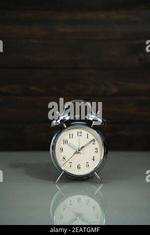 Retro alarm clock on table Stock Photo