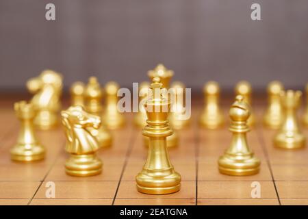 Gold king chess piece stand on wood chessboard Stock Photo
