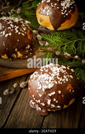 Home made buns, traditional easter bread, catkins on wooden background with osier branch Stock Photo