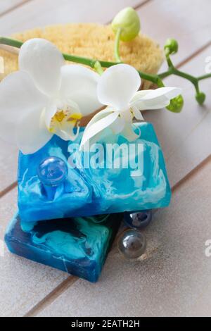 Natural handmade soap in blue water color with white orchid Stock Photo