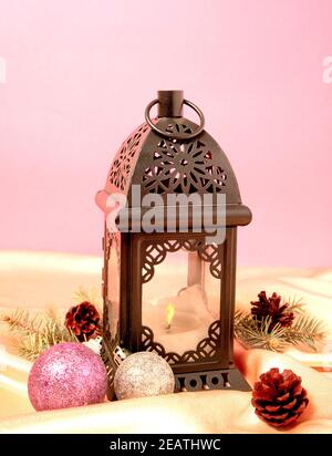 Lantern and Christmas baubles decorated on satin in pastel colors Stock Photo