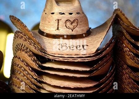Souvenir straw cowboy hats for beer lovers for sale in San Antonio