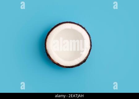 Coconuts on a blue isolate background. Coconut minimal concept. Stock Photo
