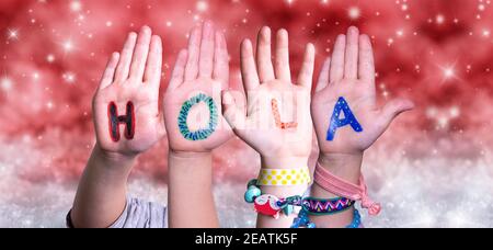 Children Hands Hola Means Hello, Red Christmas Background Stock Photo
