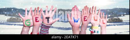 Children Hands Building Word Get Well, Snowy Winter Background Stock Photo