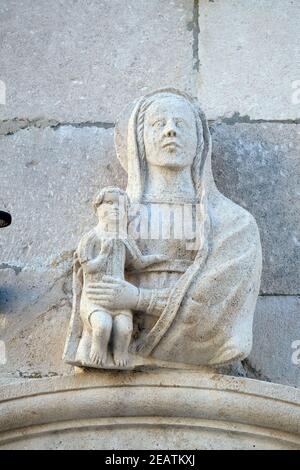 Statue of Virgin Mary with baby Jesus on the St Mark's Cathedral in the historic city Korcula at the island Korcula in Croatia Stock Photo