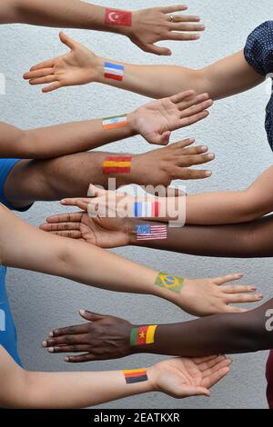 international people from different nations with flags on arms Stock Photo