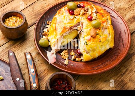 Camembert cheese baked in bacon Stock Photo