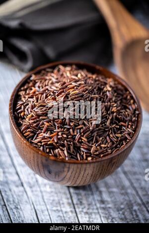 Uncooked red rice. Raw wild rice. Stock Photo