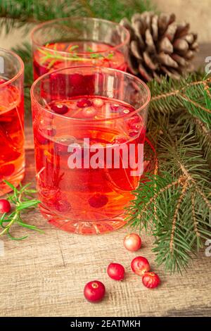 Refreshing drink cranberry and rosemary cocktail on the rustic background. Stock Photo
