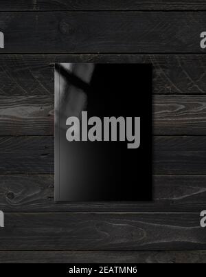 Black Booklet cover template on black wood background Stock Photo