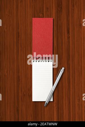 Blank open spiral notebook and pen isolated on dark wood background Stock Photo
