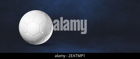 White soccer ball on a dark blue studio banner Stock Photo