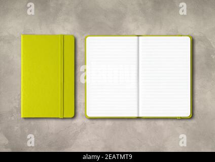 Lime green closed and open lined notebooks on concrete background Stock Photo