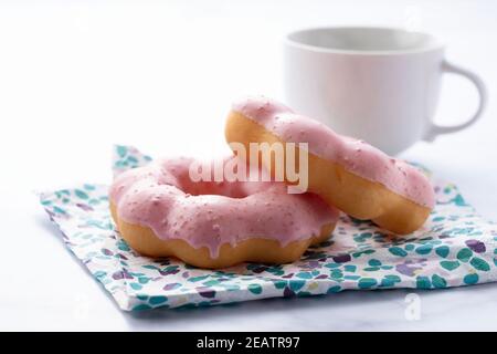 Hot coffee with pink donuts on a white background Stock Photo