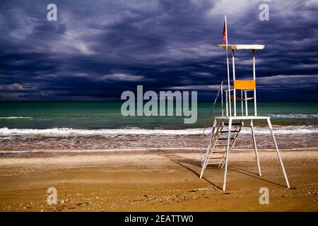 Storm clouds and rescue station for lifeguards Stock Photo