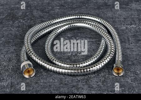 Iron water hose for shower on grey background, close up Stock Photo