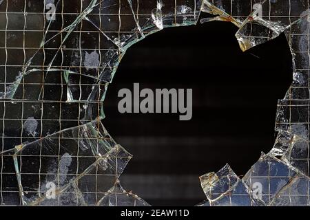 Closeup of a hole in a wired glass pane Stock Photo