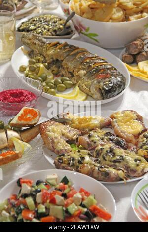 Festive table with delicious dishes. Many food on table for family holiday Stock Photo