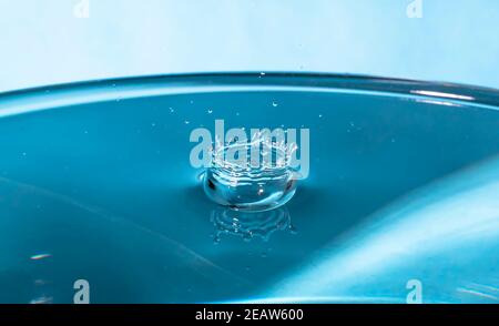 Abstract an outbreak of water. Splash of water close-up. Frozen water drop photographed at high speed.Slow dripping of liquid with air bubbles. Nature backgrounds or Wallpaper.Frozen liquid splashes Stock Photo