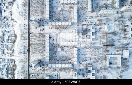 City district covered with snow aerial above drone top view Stock Photo