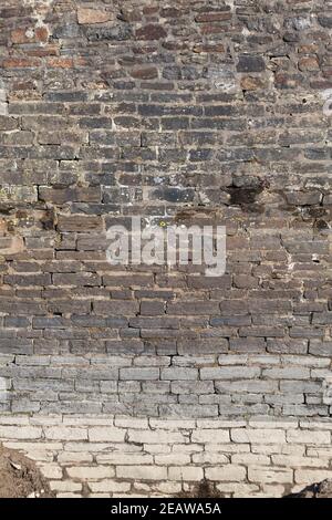 large weathered distressed red brick wall texture background Stock Photo