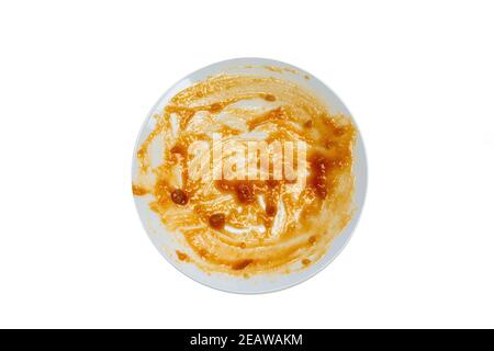 Empty white round ceramic and dirty dish after food with red sauce top view isolated on white background Stock Photo