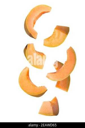 Falling sliced yellow melon isolated on white Stock Photo