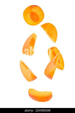 Falling sliced fresh apricot fruit isolated on white Stock Photo
