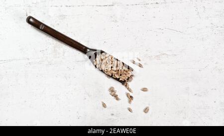 https://l450v.alamy.com/450v/2eawe0e/peeled-sunflower-seeds-in-small-wooden-scoop-placed-on-white-stone-like-board-view-from-above-2eawe0e.jpg
