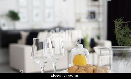 Empty wine glasses on blurred background of modern interior. Black and white interior of a room in a hotel or home. Stock Photo