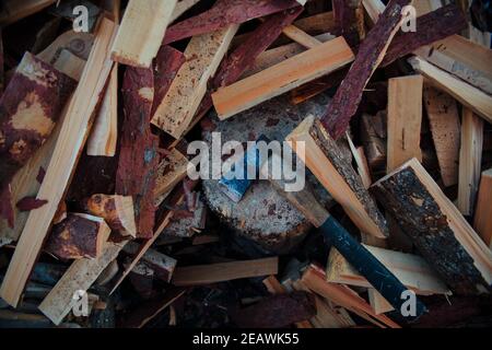 The axe lies on the background of deciduous firewood, Russia, village Stock Photo