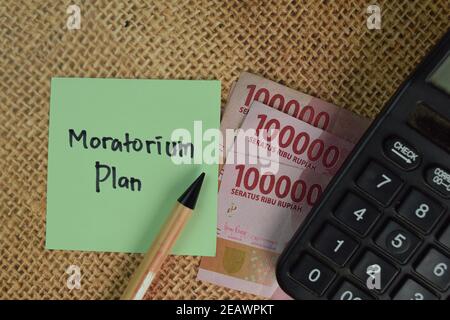 Moratorium Plan write on sticky notes isolated on Wooden Table. Stock Photo