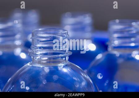 Image of the part of the cap of a few clear plastic bottles with shades of blue Stock Photo