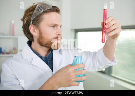man checking liquids in the lab Stock Photo