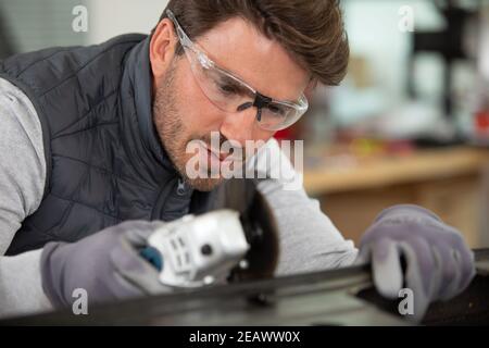 close view of man using an angle grinder Stock Photo