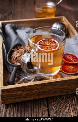 Medicinal Pau d'Arco bark tea also known as Lapacho in a glass cup on wooden background Stock Photo