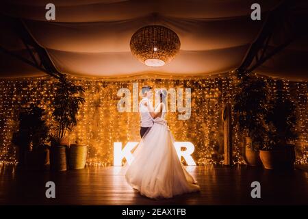 Couple dancing on their wedding day at night Stock Photo