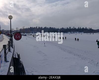 Skaters at the 5.4 km mark on the world's longest rink enjoying a fine winter weekend day. Rideau Canal, Ottawa, Ontario, Canada. Stock Photo